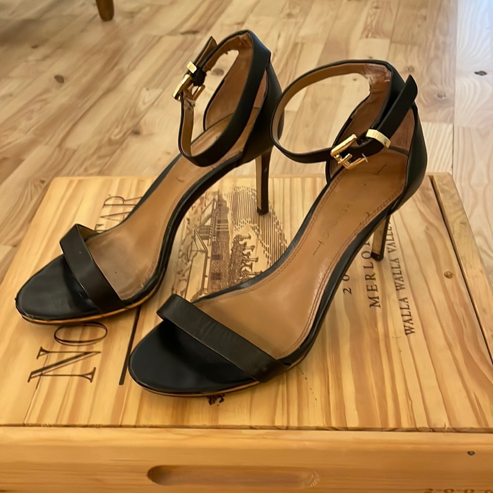 Black leather strap heels with gold buckle